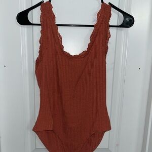 Burnt orange Lace Strap Bodysuit with snap button close.
